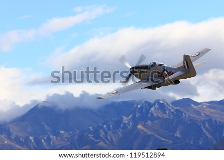 WANAKA-MARCH 03: P-51D Mustang aircraft flies over the mountains during the royal New Zealand air force 75th anniversary \