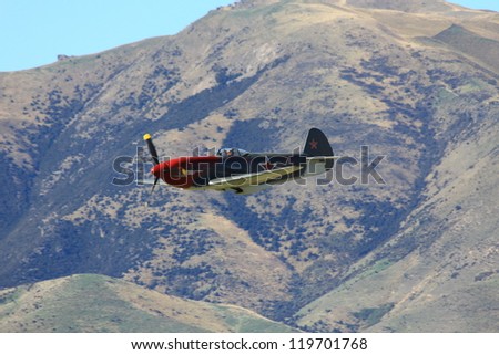 WANAKA MARCH 03: Yakovlev Yak 3-M aircraft flies over the mountains during the royal New Zealand air force 75th anniversary\