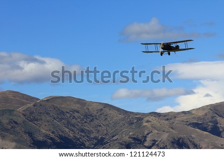 WANAKA MARCH 03: Bristol F.2B vintage aircraft flies over the mountains during the royal New Zealand air force 75th anniversary\