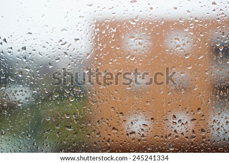 Drops of rain on window from home on rainy day
