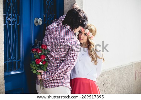 Young couple date. Man flirting with flowers gift surprise.