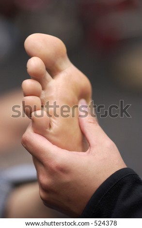 Reflexology therapy, healing hand on foot-message