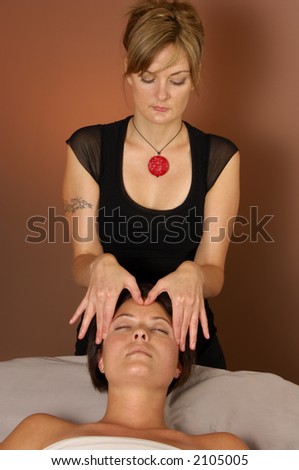 stock photo Masseuse giving head massage at spa