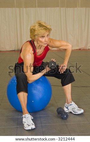 Senior Woman Weight Lifting at Fitness Center