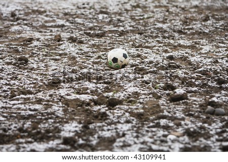 Football on snow covered acre