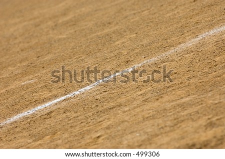 White chalk line of a baseball field. Macro with details of line and dirt.