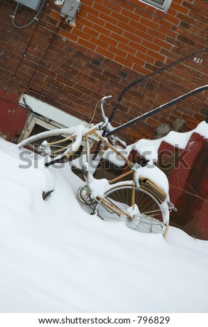 Abandoned bike covered in snow.