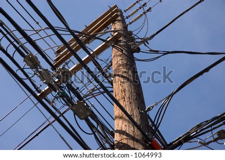 Wooden pole with lots of wires.