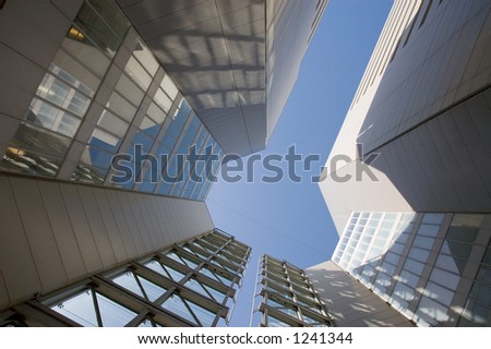 Looking up through the opening between two skyscrapers.