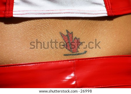 Maple leaf tattoo on the small of the back of a girl wearing PVC pants and red & white top