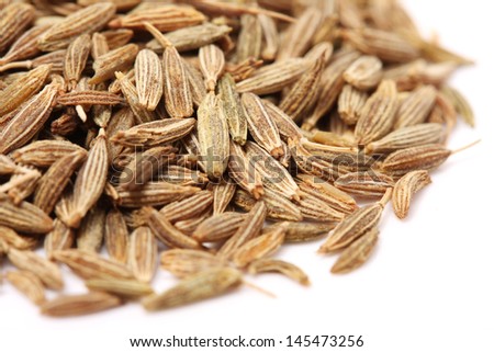 Pile of cumin seeds captured from above isolated on white