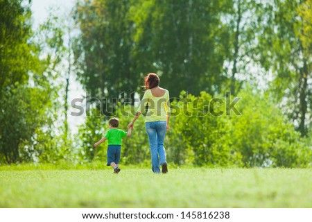 mother and child running across the field
