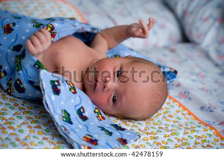child wrapped in swaddling clothes