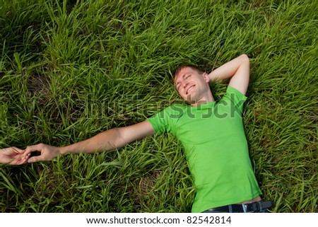 young man lying on the grass