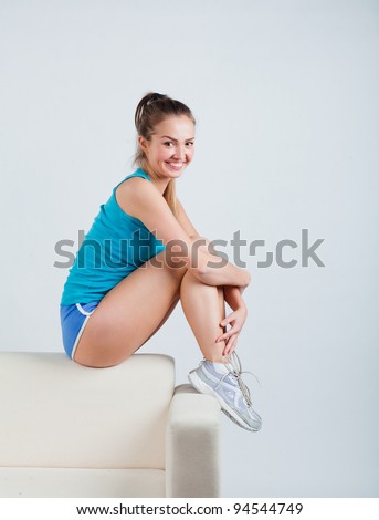 pretty athletic girl sitting hugging her knees