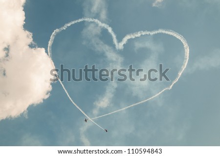 ZHUKOVSKY, MOSCOW REGION/RUSSIA - AUGUST 10: Immersion heart made in sky by team First Flight on Yak-52  at airshow devoted to 100 anniversary of Russian Air Forces on August 10, 2012 in Zhukovsky.