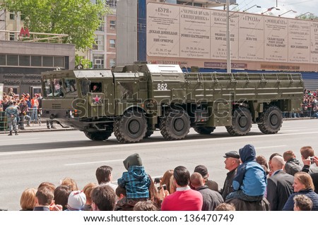 MOSCOW/RUSSIA - MAY 9: People on street side look at 9K720 Iskander (SS-26 Stone) missile system on display during parade festivities devoted to anniversary of Victory Day on May 9, 2011 in Moscow.