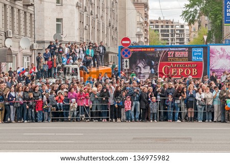 MOSCOW/RUSSIA - MAY 9: People on Tverskaya street side wait for motorcade on display during parade festivities devoted to anniversary of Victory Day on May 9, 2011 in Moscow.
