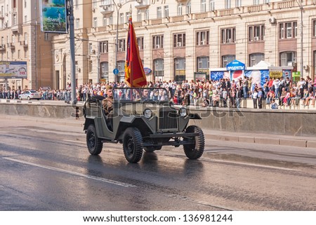 MOSCOW/RUSSIA - MAY 9: Two Soviet officers in WWII uniform with colours move in retro car (GAZ-67) on display during festivities devoted to 65th anniversary of Victory Day on May 9, 2010 in Moscow.