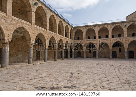Arched gallery of Khan al-Umdan viewed from paved courtyard. Old city of Acre, Israel.