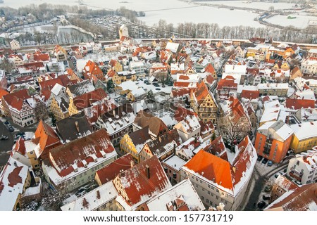 Winter panorama of medieval town within fortified wall. Top view from \