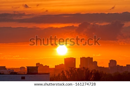 Beautiful sunset with bright Sun over skyline. Moscow, Russia.