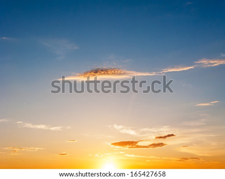 Beautiful bright sunset with sun glow on clouds