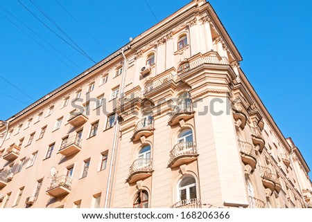 Beautiful ornate building facade corner with stucco molding against blue sky background. Moscow, Russia.