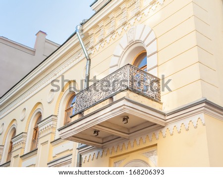 Beautiful building faÃ?Â§ades with stucco molding and bars balcony. Moscow, Russia.