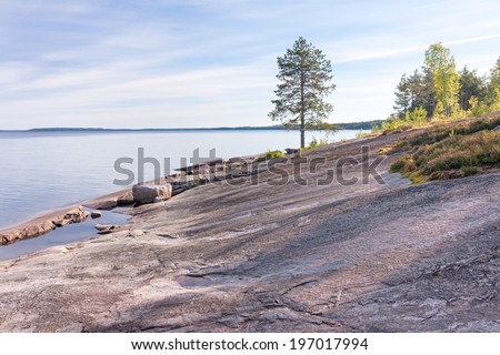View on granite shore against Onega Lake background. Besov Nos cape, Karelia Republic, Russia.