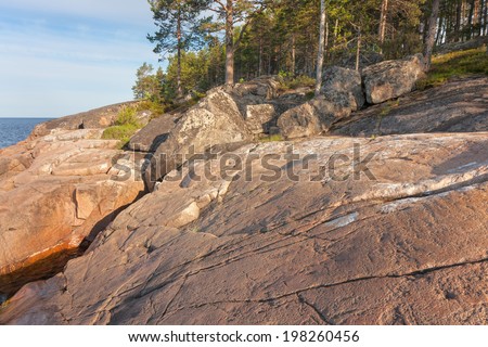 View on split granite shore of Onega Lake. Besov Nos cape, Karelia Republic, Russia.
