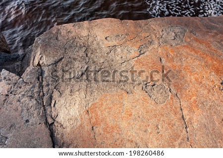 Split in granite shore of Onega Lake, Besov Nos cape, Karelia Republic, Russia.