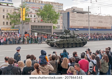 MOSCOW/RUSSIA - MAY 9: People on street side look at Russian Army T-90A tank on display during parade festivities devoted to Victory Day on May 9, 2011 in Moscow..