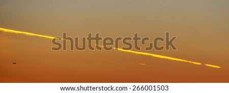 Sunset with evening glow and diagonal plane trace