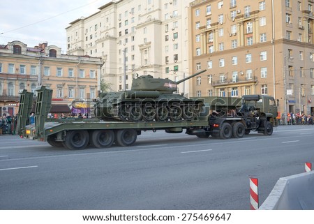 MOSCOW/RUSSIA - MAY 4: Legendary WWII T-34 tank on military transporter KAMAZ 65225 and people on Tverskaya Street on night parade rehearsal on May 4, 2015 in Moscow.