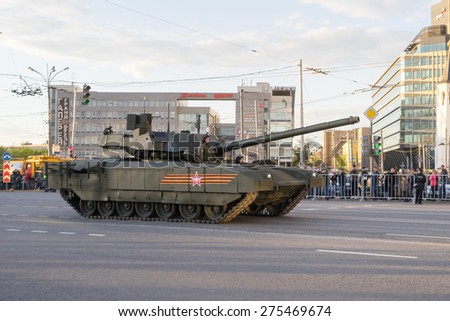 MOSCOW/RUSSIA - MAY 4: T-14 Armata main battle tank based on next generation heavy military vehicle combat platform and people on roadside on night parade rehearsal on May 4, 2015 in Moscow.