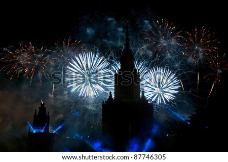 Beautiful fireworks on Lomonosov Moscow State University Main Building background at night.