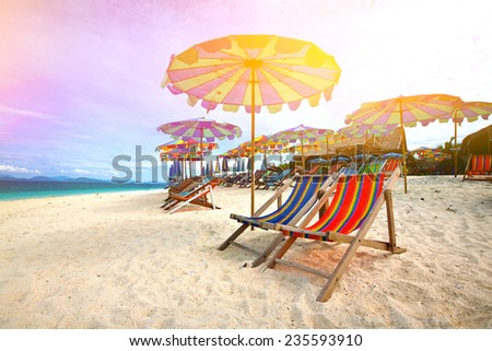 Colorful parasols on a tropical island beach.