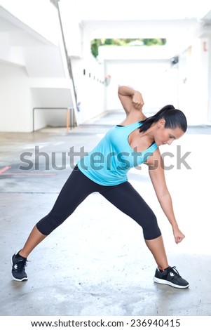 Beautiful hispanic sport woman demonstrating martial art stance , outdoor. Concept of healthy lifestyle.
