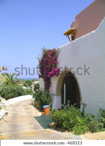 Beautiful front entrance of a stone house facing the sea in bright sunshine