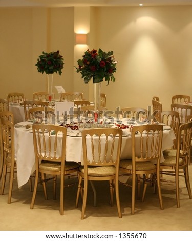 stock photo An arrangement of wedding reception tables with tall vases 