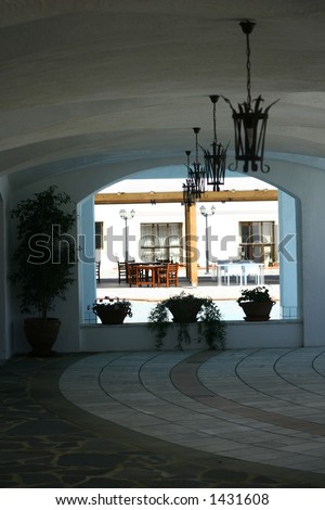 A dome arch window overlooking the pool and a restaurant setting