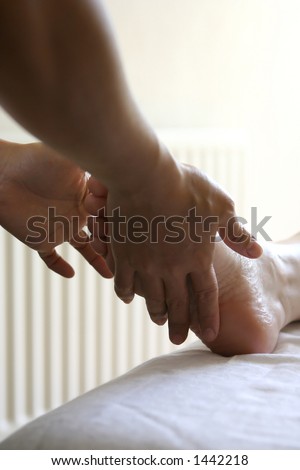 A lady receiving a foot massage as part of a holistic massage treatment