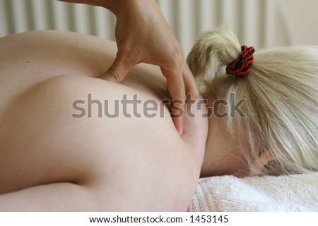 A lady receiving a shoulder massage as part of a holistic massage treatment