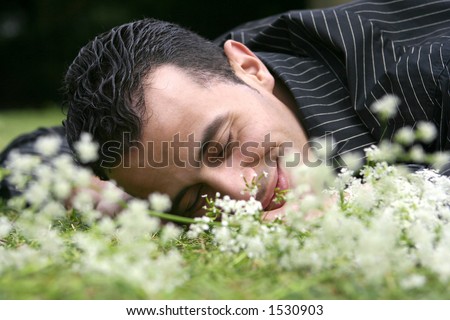 Man feeling relax, laying in the field feeling romantic and happy