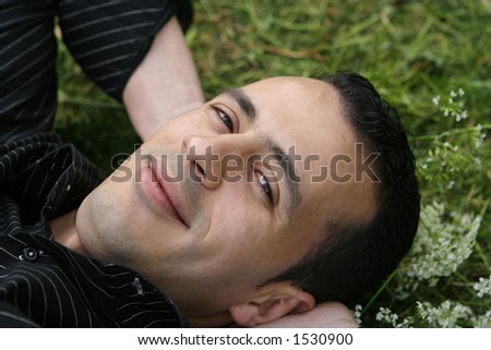 Man feeling relax, laying in the field feeling romantic and happy