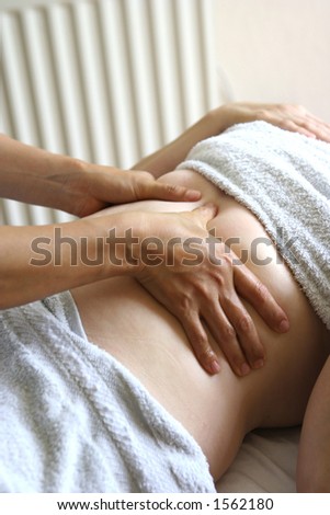 A lady receiving a chest massage as part of a holistic massage treatment