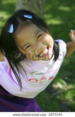 A young Vietnamese girl plays happily in the park