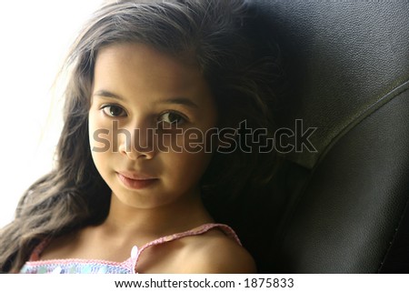 A young girl relaxes in a comfy chair on a warm evening