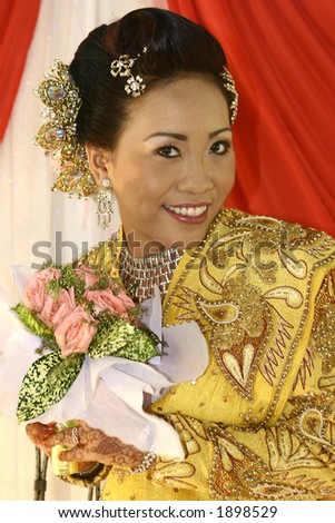 A Malay bride posing in her traditional costume as part of the  Malay wedding ceremony.